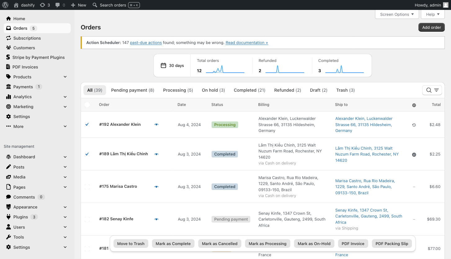 Screenshot of the order list in WooCommerce. A couple orders are checked and the bulk actions are showing, with PDF Invoice and PDF Packing Slip being two of the actions, which come from the PDF Invoices & Packing Slips for WooCommerce plugin. Also, the PDF Invoices menu item can be seen on the left in the WordPress admin menu.